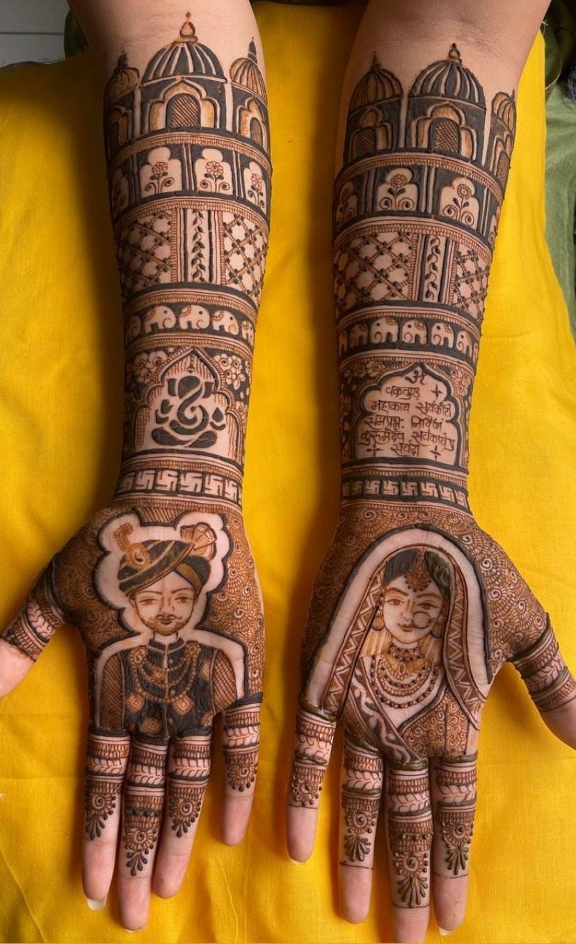 Mehndi artist applying henna on a client's hand